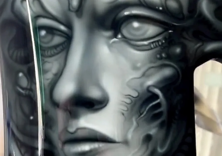 Biomechanical face airbrushed in greyscale on a panel