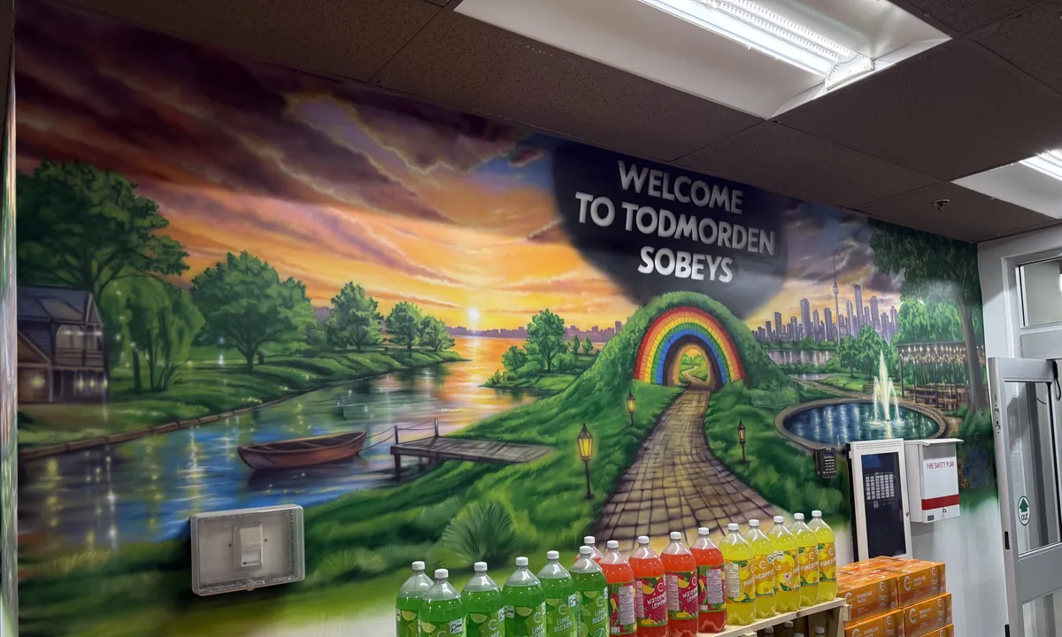 Todmorden Sobeys mural — river valley at sunset with a rainbow footpath
